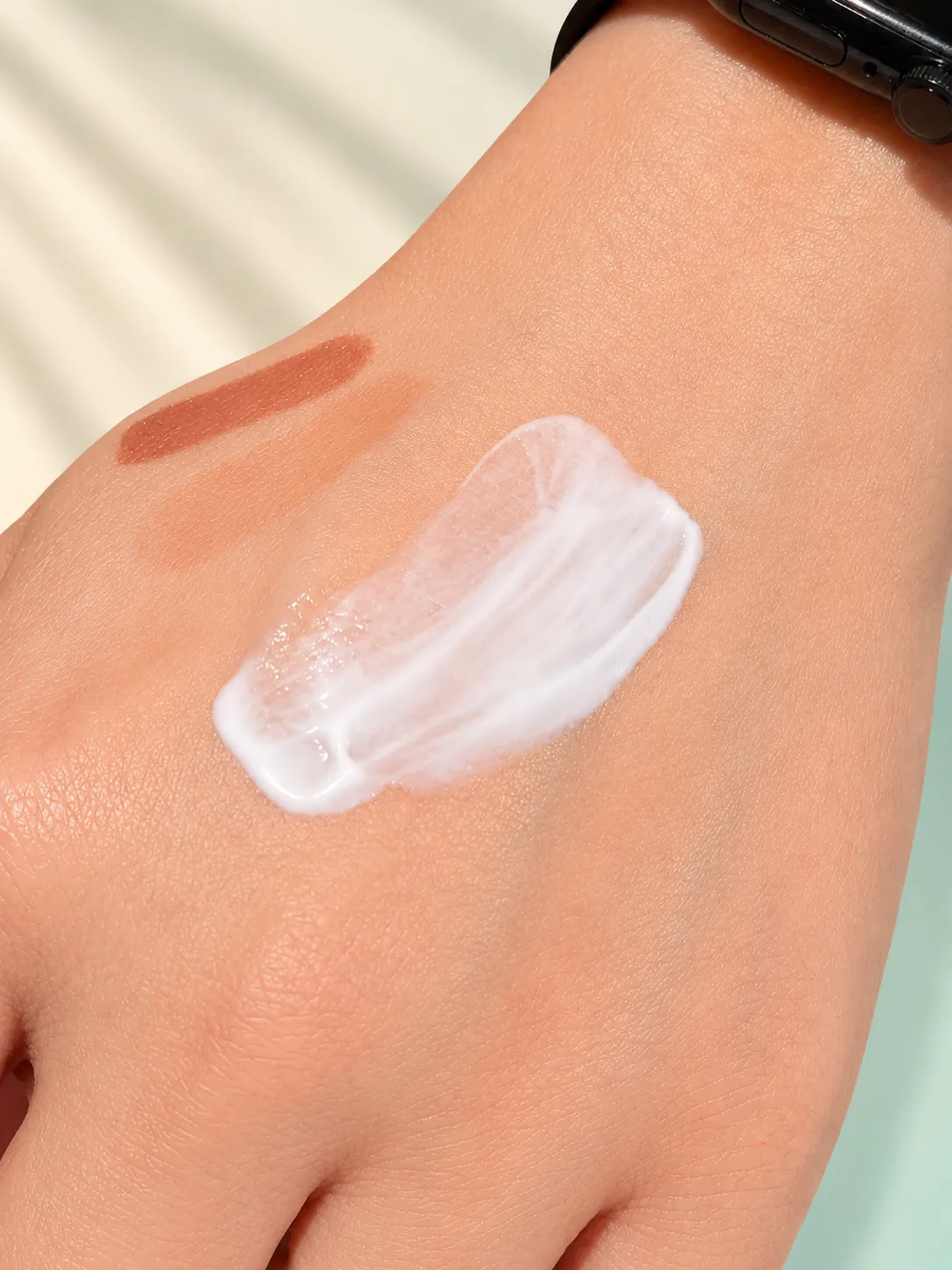 The sun serum blended out on skin, showing its watery, near-invisible finish